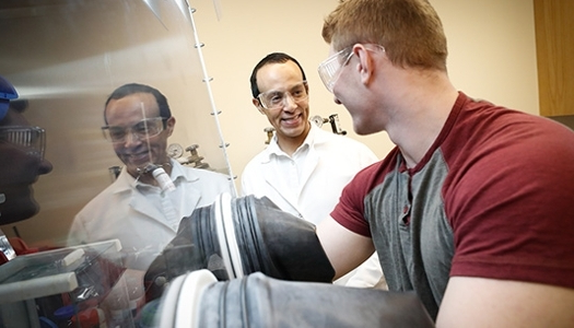 Student working in a lab with a faculty member